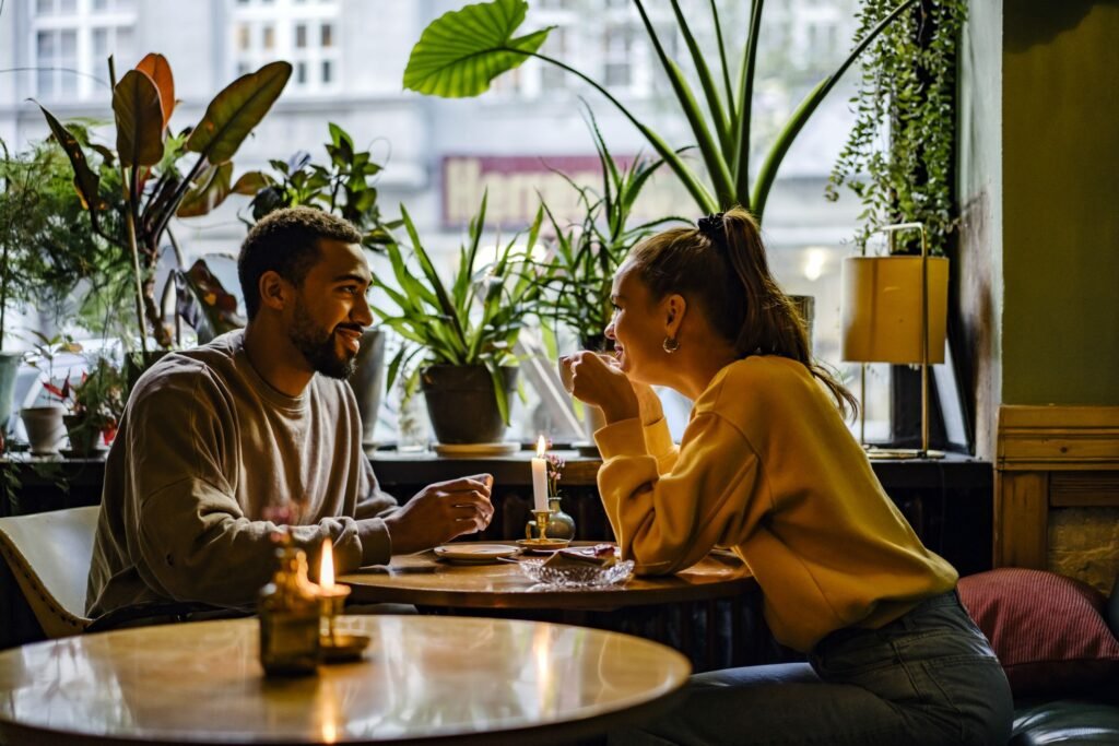 Two people laughing together while sharing stories, emphasizing positive speed dating interactions.